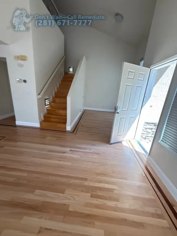 Finished hardwood floor running to the staircase and front door
