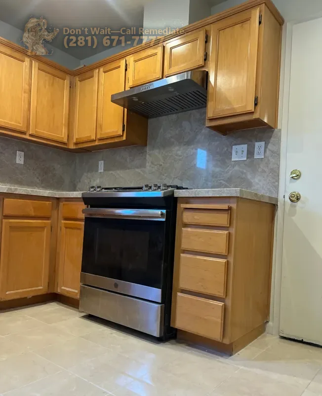Finished kitchen: oak cabinets, stone countertop and backsplash, stainless range